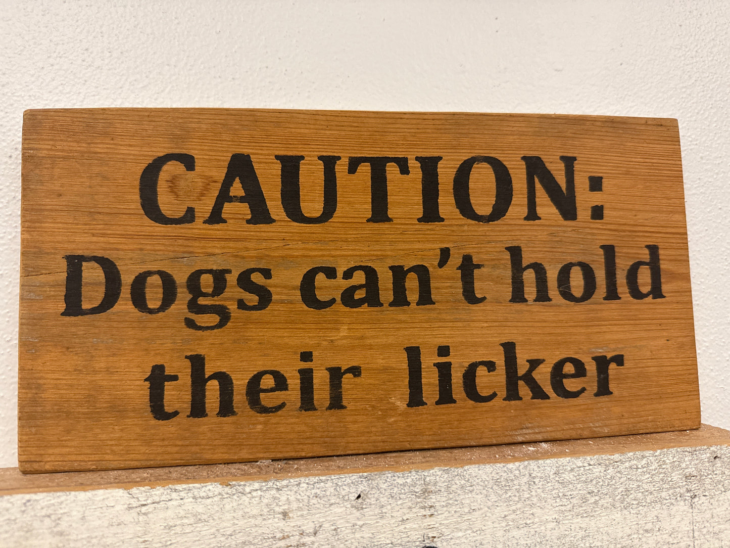 Caution: dogs can’t hold their licker wooden novelty sign