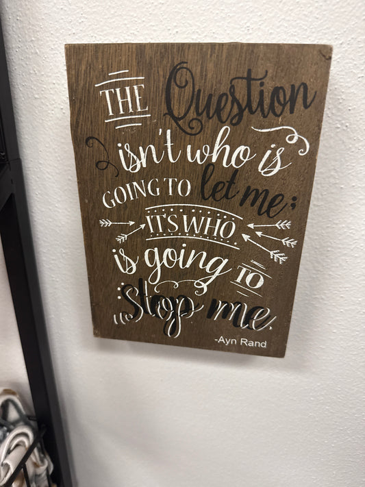 The question isn’t who is going to let me it’s who is going to stop me wooden sign